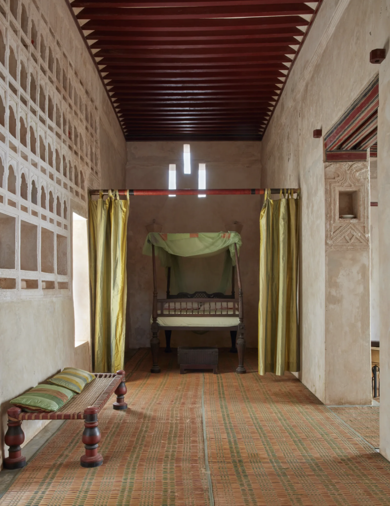 Traditional bedroom with a wooden bed and decorative shelving.
