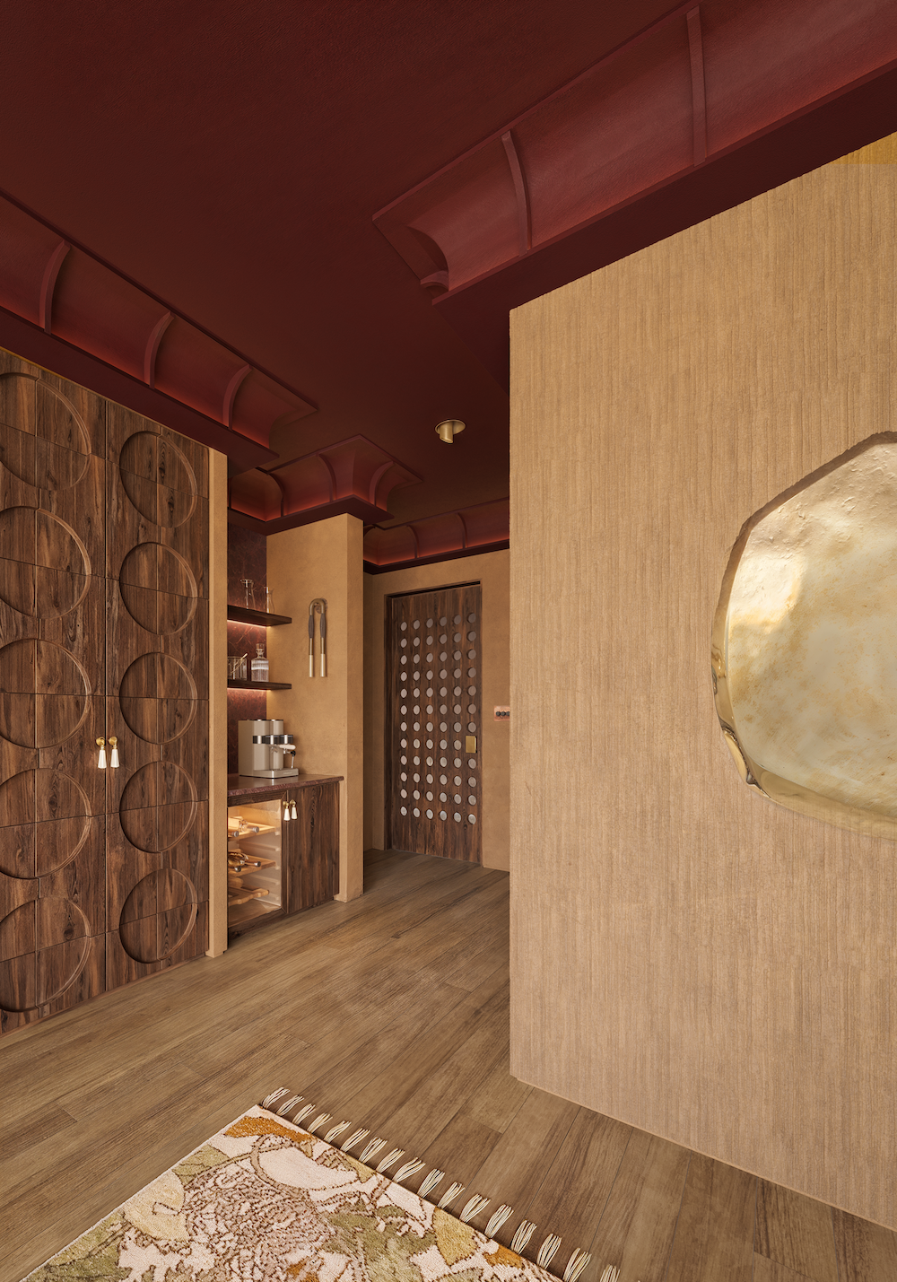 Interior detail of a luxury suite entrance featuring textured walls, sculptural ceiling details, warm wood cabinetry, and ambient lighting.
